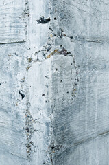 Texture of board formed concrete wall showing wood grain and stone aggregate.  