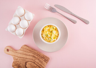 Scrambled eggs on bowl,, top view, flat lay, light colors, concept