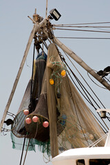 Fishing nets hanging on mast of shrimp boat