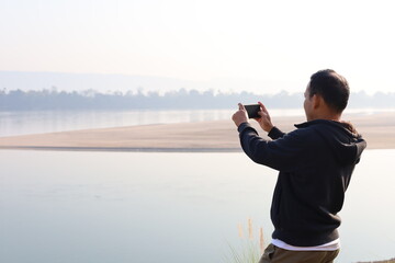 person taking a picture with a mobile phone