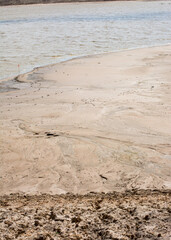 Abstract dirt and sand pattern next to lake