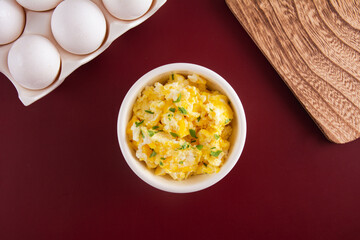 Fresh scrambled eggs with parsley, top view, flatlay