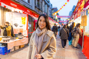 Woman go Dihua street in Taipei at night at the period of Chinese New Year