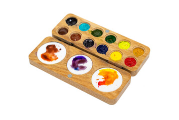 Wooden watercolor palette. Watercolor tray with watercolor set isolated on a white background.