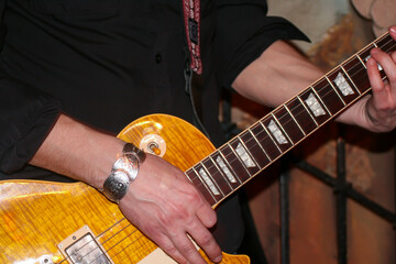 The guitarist plays a close -up of an electric guitar