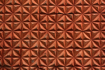 Texture of brown rhombs of the concrete wall of the house built in the USSR