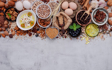 Ingredients for the healthy foods selection. The concept of superfoods set up on white shabby concrete background with copy space.