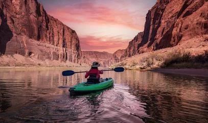 Foto auf Acrylglas Lachsfarbe Adventurous Woman on a Kayak paddling in Colorado River. Glen Canyon, Arizona, United States of America. Sunrise Sky Art Render. American Mountain Nature Landscape Background.