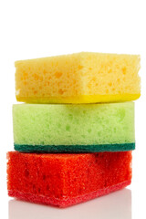 Multi -colored sponges for washing dishes on each other. Devices for cleaning the house, cleanliness and health. Isolated on a white background. Close-up. Vertical