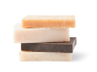 Stack of different soap bars isolated on white background