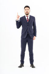 A man in a suit posing with his index finger up