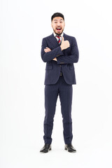 A man in a suit doing a thumbs up pose