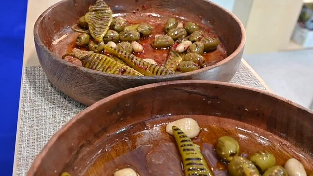 Closeupsof grilled green olive pickles are displayed during the Gulf Food exhibition, United Arab Emirates