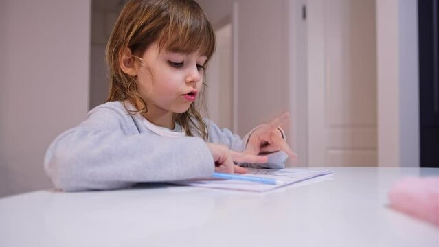 Smart Young Caucasian Girl Preshooler Doing Math Homework Counting Numbers with Her Fingers