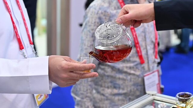 A visitor getting a free tea sample during the Gulf Food Exhibition in the United Arab Emirates