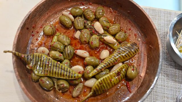 Closeup of grilled green olive, Garlic and Green Chilli pickles are displayed during the Gulf Food exhibition