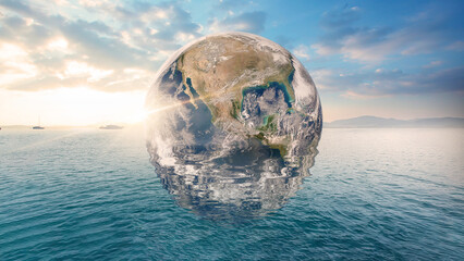 Planet Earth is floating over the ocean. Global warming, Travel Concept. (Elements of this image...