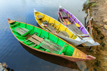 Beautiful colourful wooden boats at lake shore.