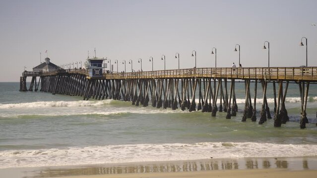 Imperial Beach Pier in Southern California with waves during a sunny day