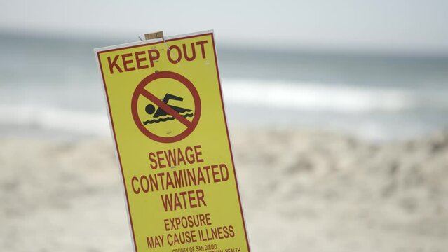 Keep Out Sewage Contaminated Water Beware Sign on Imperial Beach California sunny day - close up slow motion