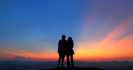 back view silhouette of a couple against twilight light