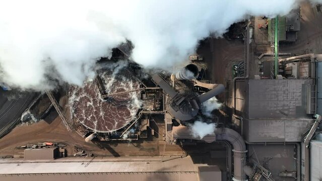 Top down aerial of steam and smog coming from US Steel Edgar Thomson Plant in Braddock, PA. Drone into steam.
