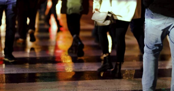 People crossing zebra crossing on a wet rainy day, people waking both sides, night, lights, Niagara Falls, Canada