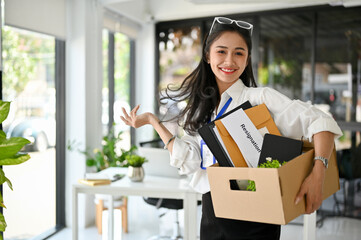 Smiling Asian female office worker, celebrating her resignation, happy to quit her job.