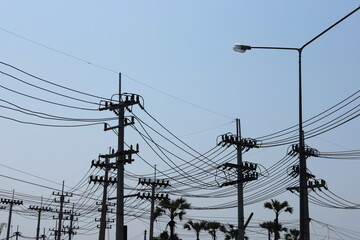 Silhouette of a strong electric line on a pole. Many high voltage transmission lines in front of a...