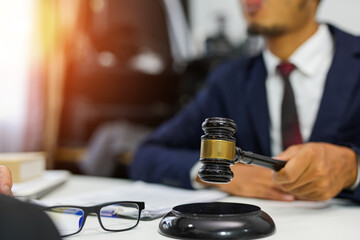 Fototapeta na wymiar judge on wooden table And experienced lawyers meet with clients and give advice behind the scenes. legal services legal consulting concept