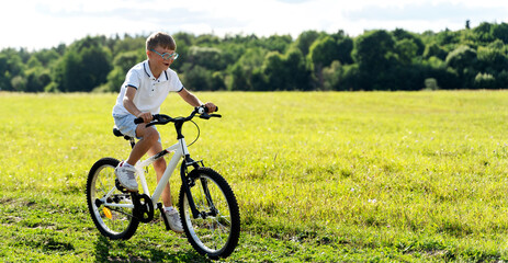 Fototapeta premium a boy rides a bicycle in nature