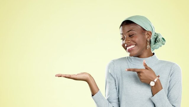 Happy, mockup and presentation with a black woman in studio on a yellow background for product marketing. Smile, mock up and space with an attractive young female showing placement for advertising