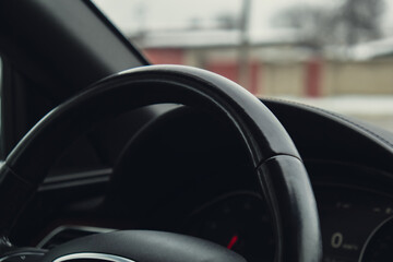 Black luxury modern car Interior. Steering wheel, shift lever and dashboard. Black leather Detail...