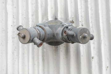 close up fire hydrant water pipe connector installed in wall for connect fire truck support water put out fire in building when emergency, wall background. Fire fighting equipment, safety, standpipe, 