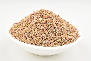 Ajwain seeds in bowl on white background