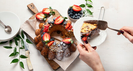 Pound Cake cake with strawberry, close-up on the table. Horizontal view from above..Pound Cake cake with mint and strawberry close-up on the table. Horizontal view from above.