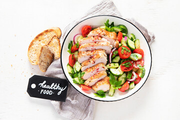Salad with chicken meat. Fresh vegetable salad with chicken breast. Meat salad with chicken fillet and fresh vegetables on plate.