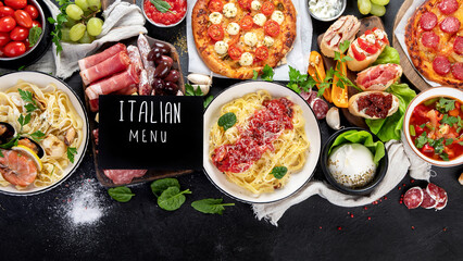 Italian food dishes on dark background.