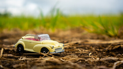 South Minahasa, Indonesia : February 2023, toy car on green grass
