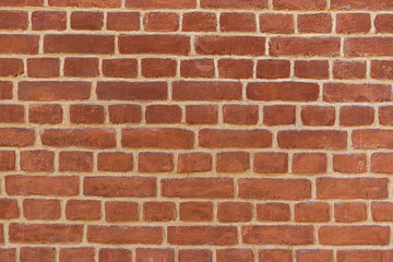 Empty brick red wall. background of a old brick house.