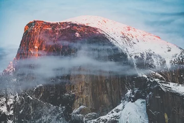 Photo sur Plexiglas Half Dome Yosemite national park in California during winter season with snows and ice dramatic sunset colorful sky Chapel half dome winter storm blizzard