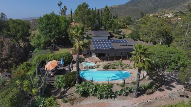 Establisher aerial shot of real estate house with swimming pool and solar cells