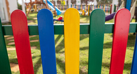 Colorful fence on the playground in the park.