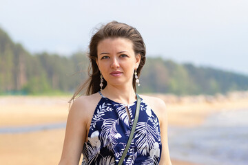 portrait young beautiful woman, girl on beach breathing fresh air. concept of freedom, vacation, travel