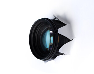 Hidden camera lens through hole in white paper,Concept of paparazzi or hidden camera