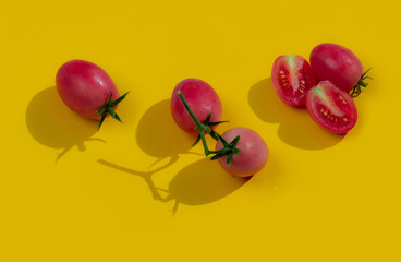 Fresh cherry tomato on yellow background