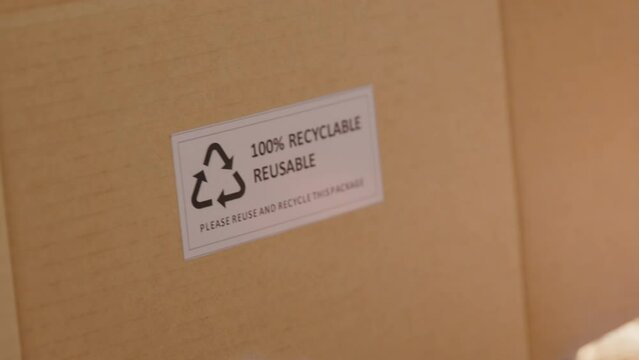 Eco vendor go green packaging parcel carton box in net zero waste store asian seller retail shop. Earth care day small SME owner asia people wrap reuse brown paper pack gift reduce plastic free order.