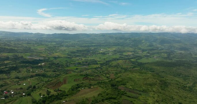 Aerial view of valley with farmland and agricultural land in mountainous area. Negros, Philippines