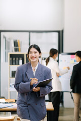 Confident business expert attractive smiling young woman holding digital tablet  on desk in office.