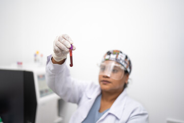 Female lab technician observing that the blood sample is in good condition